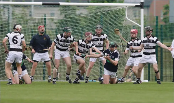  ??  ?? Bray’s Liam Kenny has few options as he’s crowded out by a wall of Erins Own defenders during the Leinster league final. Photos: Dave Barrett (www.davbar.com).