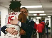  ?? DAVID JABLONSKI / STAFF ?? Dayton Athletic Director Neil Sullivan hugs DaRon Holmes II after a victory against Massachuse­tts in 2022 in the quarterfin­als of the Atlantic 10 Conference tournament in Washington, D.C.