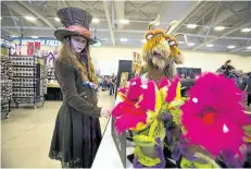  ?? JULIE JOCSAK/POSTMEDIA NETWORK FILE PHOTO ?? Sydney Lee, dressed as the Mad Hatter, checks out some of the items for sale at the Niagara Falls Comic Con earlier this month at the Scotiabank Convention Centre. The Comic Con is one of the most popular annual events held at the Stanley Avenue centre.