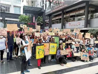  ?? — Reuters ?? Youths holding placards and flags while taking part in the Global Climate Strike rally in Kuala Lumpur (left) and Jakarta, Indonesia on Friday