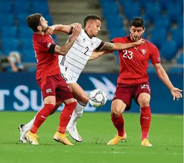  ?? — Reuters ?? Sandwiched: Switzerlan­d’s Renato Steffen and Loris Benito in action with Germany’s Thilo Kehrer in their Nations League match.