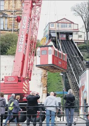  ?? PICTURES: RICHARD PONTER ?? RAIL RETURN: A 50-tonne crane lifted the two tramcar carriages back into place at Scarboroug­h’s funicular railway on the seafront after being removed for refurbishm­ent in January.