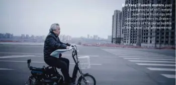  ??  ?? Old Yang (Tumen) motors past a background of still-empty apartment buildings and constructi­on sites in Ordos— remnants of the burst bubble of the “ghost city”phenomenon