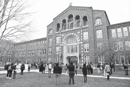  ?? Photos by Andy Cross, The Denver Post ?? Students and staffers of South High School hold a 9-minute, 29-second moment of silence for George Floyd on Wednesday. Students and staff members held the event after classes ended for the day.