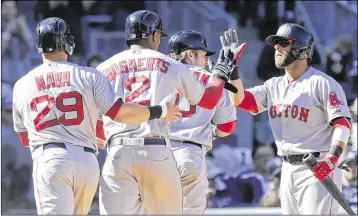  ?? FRANK FRANKLIN II / ASSOCIATED PRESS ?? Dustin Pedroia (right) greets the Red Sox’s Daniel Nava, Xander Bogaerts and Ryan Hanigan after they scored on Brock Holt’s eighth-inning double. Holt, the only position player not to play Friday, had four hits.