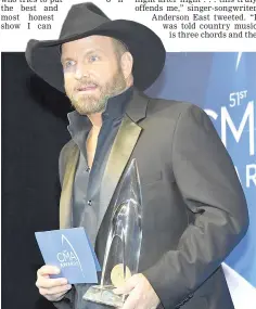  ??  ?? Garth Brooks holds his award for Entertaine­r of the Year. — Reuters photo