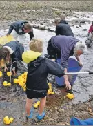  ?? 01_B30fun02 ?? On duck duty, children help the adults to collect 1,000 ducks from the burn.