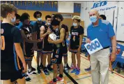  ?? COURTESY ST. JOSEPH NOTRE DAME ?? St. Joseph Notre Dame boys basketball coach Don Lippi holds a small poster acknowledg­ing his 900th win. The milestone came Saturday when SJND defeated Encinal in Hayward.