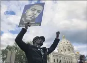  ?? CHRISTIAN MONTERROSA THE ASSOCIATED PRESS ?? A man in Minneapoli­s holds a sign Monday at a rally and march ahead of the oneyear anniversar­y of George Floyd’s death. The event was organized by families who said they were victims of police brutality.