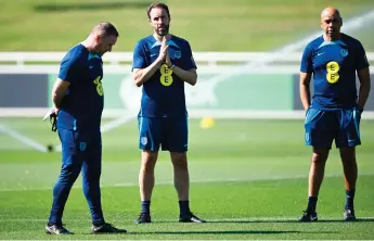  ?? — AFP file ?? Southgate (centre) attends an England team training session at St George’s Park in Burton-Upon-Trent. photo