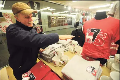  ?? Brian A. Pounds / Hearst Connecticu­t Media file photo ?? Fairfield University Class of 1970 graduate and Assistant Vice President James Fitzpatric­k points out the school’s 75th anniversar­y merchandis­e in Fairfield in 2017. He retired earlier this month.