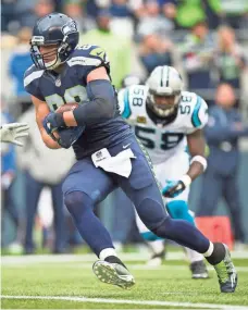  ?? TROY WAYRYNEN, USA TODAY SPORTS ?? Tight end Jimmy Graham, left, broke through for his first 100yard game with the Seahawks last Sunday vs. the Panthers.
