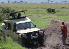  ??  ?? Getting stuck is part of the fun of navigating the muddy roads that wind through Kenya’s Maasai Mara region.