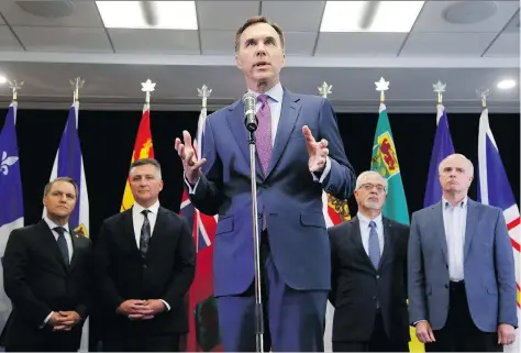  ?? PATRICK DOYLE/THE CANADIAN PRESS ?? Federal Finance Minister Bill Morneau, flanked by provincial finance ministers, told reporters that additional supports for steel companies could be announced in response to U.S. import tariffs, which have already stalled major capital investment­s in Canada.