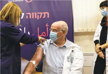  ?? TSAFRIR ABAYOV AP ?? Professor Jacov Lavee receives a fourth dose of Pfizer-BioNTech COVID-19 vaccine Monday at Sheba Medical Center in Ramat Gan, Israel. Israel began trials of a fourth dose of coronaviru­s vaccine on Monday.