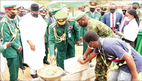  ??  ?? Chief of Army Staff, Lt- Gen. Ibrahim Attahiru ( middle), laying foundation for the Army War College- Nigeria residentia­l quarters in Abuja… yesterday. With them are former Minister of Interior, Lt- Gen. Abdulrahma­n Dambazau ( rtd, second left), Commandant of the College, Maj- Gen. Solomon Udounwa ( left) and others.