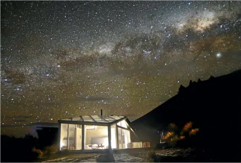  ?? SKYSCAPE ?? The Skyscape lodge is illuminate­d against the majestic night sky.