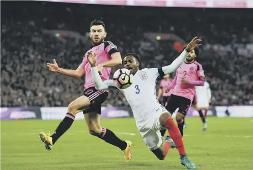  ??  ?? Robert Snodgrass challenges England defender Danny Rose when the sides met in November’s World Cup qualifier at Wembley.