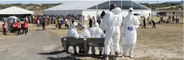  ?? BRENDAN MAGAAR African News Agency (ANA) ?? CATERERS providing the homeless with food in full protective clothing at the Strandfont­ein Sports Complex that is being used to house a minimum of 2 000 homeless people for the duration of the Covid-19 lockdown. |