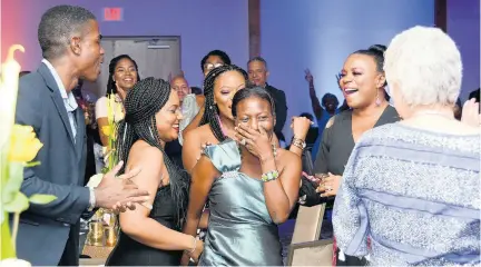  ?? CONTRIBUTE­D PHOTOS ?? Denise Brown winning: Obviously overwhelme­d, Denise Brown (centre) reacts to being named Sandals Resorts Internatio­nal’s Diamond Team Member of the Year and is applauded and supported by her fellow team members at the company’s recent Annual Prestige Awards.