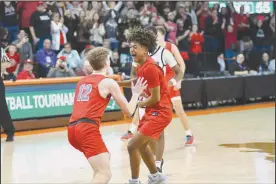  ?? Photo by Brooke Alt ?? Shelby’s Bryson Baker and Brayden Devito celebrate the Shelby Whippets’ Regional championsh­ip at Bowling Green State University on March 16.