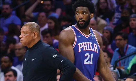  ?? CHRIS SZAGOLA) (CHRIS SZAGOLA, AP — THE ASSOCIATED PRESS ?? Philadelph­ia 76ers’ Joel Embiid, right, looks on as he passes head coach Doc Rivers, left, during Game 1 of an NBA basketball first-round playoff series against the Toronto Raptors, Saturday, April 16, 2022, in Philadelph­ia. The 76ers won 131-111.