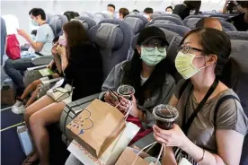  ?? — reuters ?? Staycation: People taking part in the fake travel experience at the Songshan airport in Taipei.