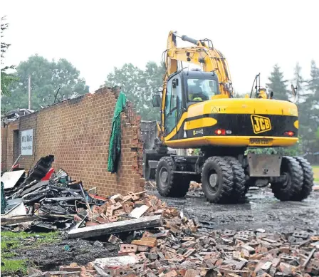  ??  ?? Diggers moved in to clear away the rubble after the fire last year.