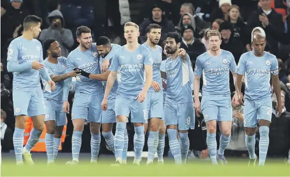  ?? ?? Manchester City’s Aymeric Laporte celebrates scoring their side’s fifth goal of the game with team-mates.