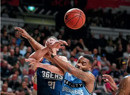  ??  ?? Adelaide 36ers player Daniel Johnson, left, and New Zealand Breakers player Patrick Richard contest possession yesterday.