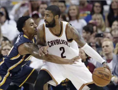  ?? TONY DEJAK — THE ASSOCIATED PRESS ?? Indiana Pacers’ Jeff Teague, left, reaches in as Cleveland Cavaliers’ Kyrie Irving drives to the basket in the second half in Game 1of a first-round NBA basketball playoff series, Saturday in Cleveland.