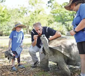  ?? PROVIDED BY ZOO MIAMI/MAKE-A-WISH SOUTHERN FLORIDA ?? Dale Zimmerman, Ron Magill and Heidi Zimmerman at Zoo Miami on March 18.