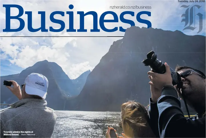  ?? Photo / Mike Scott ?? Tourists admire the sights at Milford Sound.