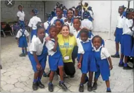  ?? CONTRIBUTE­D PHOTO ?? Hope For Kids Foundation that includes her name keeps Christine Gianacaci alive. This photo from a day in Haiti shows Gianacaci in her comfort zone of loving children.