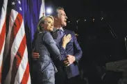  ?? Santiago Mejia / The Chronicle ?? Gavin Newsom embraces his wife, Jennifer Siebel Newsom, during his election night party in S.F.