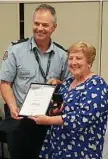  ?? Photo: Contribute­d ?? COMMUNITY Rosemary Morley award from commission­er Zsombok. SERVICE: receives an deputy Stephen