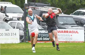  ?? Photograph­s by CRAIG JOHNSON. ?? Wonthaggi’s Wayne Luke gets boot to ball ahead of Warragul’s Jason Neville.