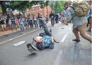  ?? MYKAL MCELDOWNEY / INDYSTAR VIA USA TODAY NETWORK ?? A white nationalis­t is knocked unconsciou­s by a counter protester at Emancipati­on Park, formerly known as Lee Park, during the “Unite the Right” rally.