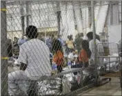  ?? CUSTOMS AND BORDER PROTECTION’S RIO GRANDE VALLEY SECTOR VIA AP ?? In this June 17 file photo provided by U.S. Customs and Border Protection, people who’ve been taken into custody related to cases of illegal entry into the United States, sit in one of the cages at a facility in McAllen, Texas. U.S.