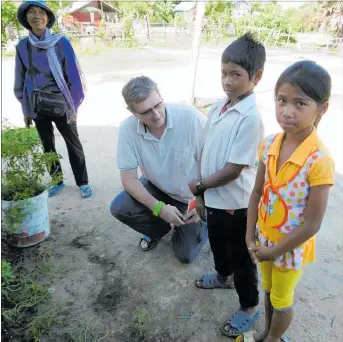  ?? PHOTOS / SUPPLIED ?? Hope project co-ordinator Richard Brown with children in Cambodia.