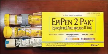  ?? JOE RAEDLE/GETTY IMAGES NORTH AMERICA/AFP ?? An EpiPen, which dispenses epinephrin­e through an injection mechanism for people with severe allergies, made by Mylan Inc on August 16 in Hollywood, Florida.