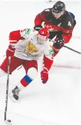  ?? JASON FRANSON / THE CANADIAN PRESS ?? Russia’s Mikhail Abramov,
in the white jersey, knows he will have to show the Toronto Maple
Leafs that he is able to compete and play hard without the puck if he’s to
move up the ranks.