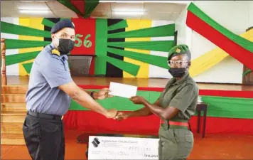  ?? ?? Commander Sean Harmon (left) presents Private Shiquanna Blair of DHQ/IG Secretaria­t with her cash incentive. (GDF photo)