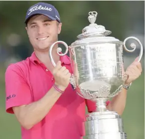  ?? (Photo by Chris O’Meara, AP) ?? Justin Thomas lifts the Wanamaker Trophy after winning the PGA Championsh­ip at the Quail Hollow Club Sunday.