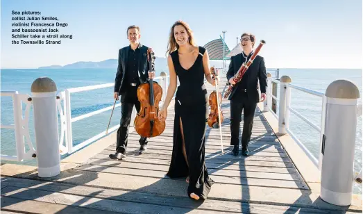  ??  ?? Sea pictures: cellist Julian Smiles, violinist Francesca Dego and bassoonist Jack Schiller take a stroll along the Townsville Strand