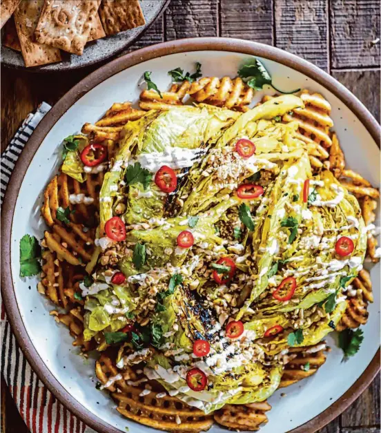  ?? Amisha Gurbani/Special to The Chronicle ?? Indian Spiced Braised Cabbage With Waffle Fries and Lavash Chips is an Ottolenghi-inspired riff on a classic dish.