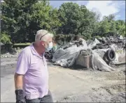  ?? Will Waldron / Times Union ?? Wayne Holmes stands next to the remains of his home on July 1 in Albany. The structure was demolished after it caught fire. Holmes is upset with the city’s response to the fire, and subsequent demolition.