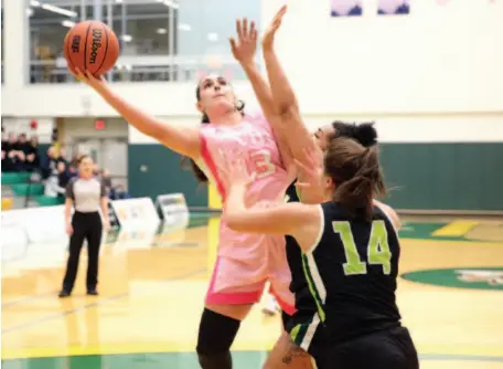  ?? CITIZEN PHOTO BY JAMES DOYLE ?? Vasiliki Louka of the UNBC Timberwolv­es keeps the ball out of reach of two University of the Fraser Valley Cascades defenders as she goes for two points on Friday night at the Northern Sport Centre.