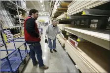  ?? THE ASSOCIATED PRESS FILE PHOTO ?? When the home improvemen­t platform Houzz surveyed 1,000 homeowners who use the site in April, nearly 80% said they’re considerin­g remodeling changes that would help them enjoy their houses more. In this file photo, a store manager assists a customer at a Lowe’s retail home improvemen­t store, in Framingham, Mass.