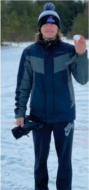  ??  ?? Ignace student Gavin Breube holds an egg that survived the 5-metre drop